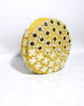 Round GOLDEN  yellow CLUTCH BAG with floral patterns on a white background