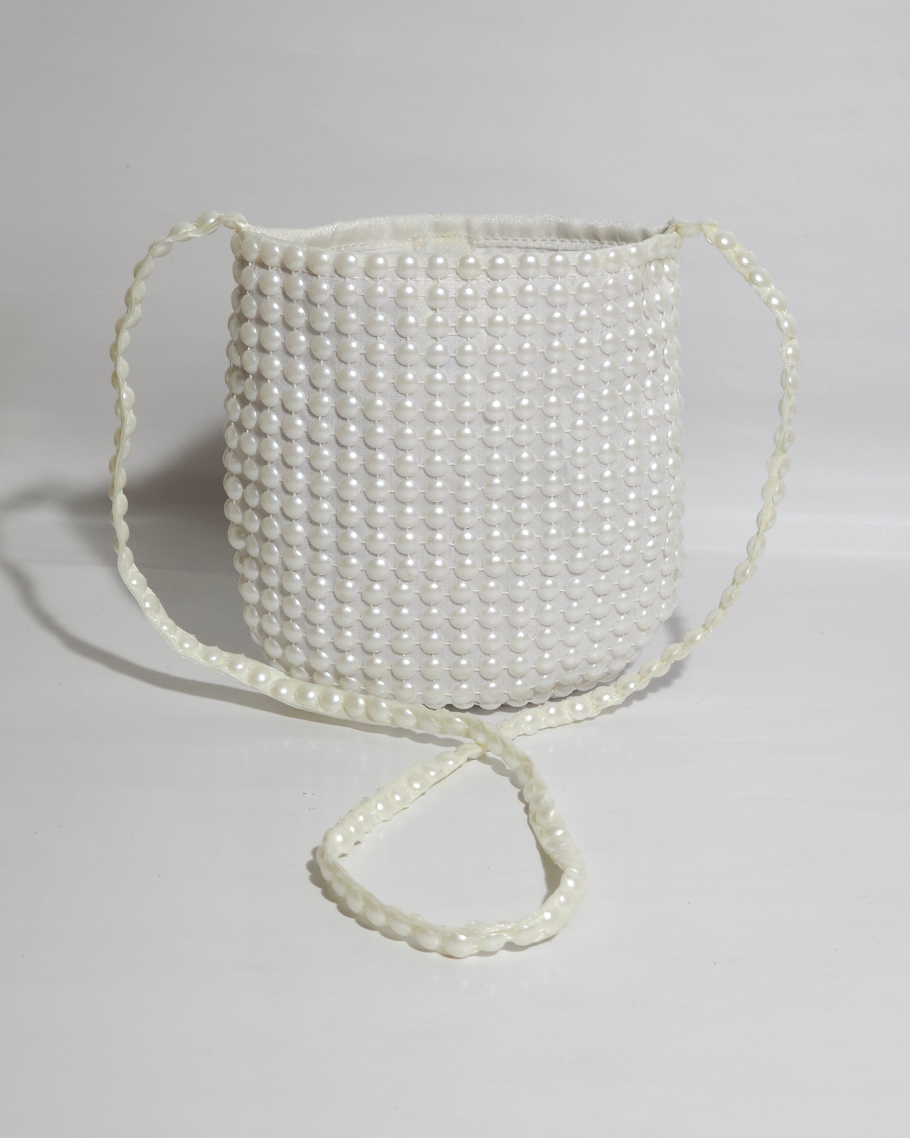 Pearl-handled bag on a light gray background