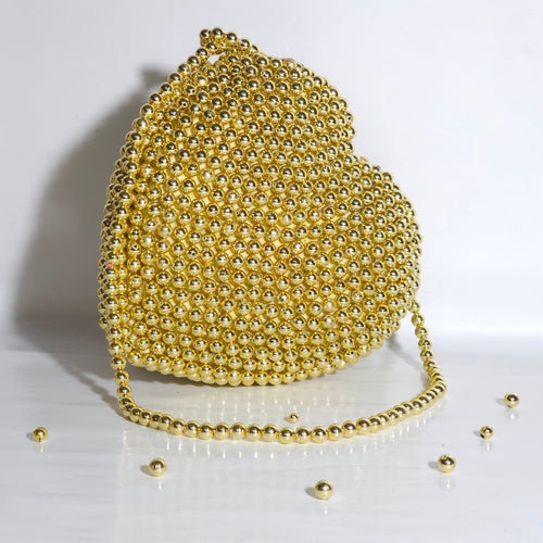 Gold beaded handbag on a white background