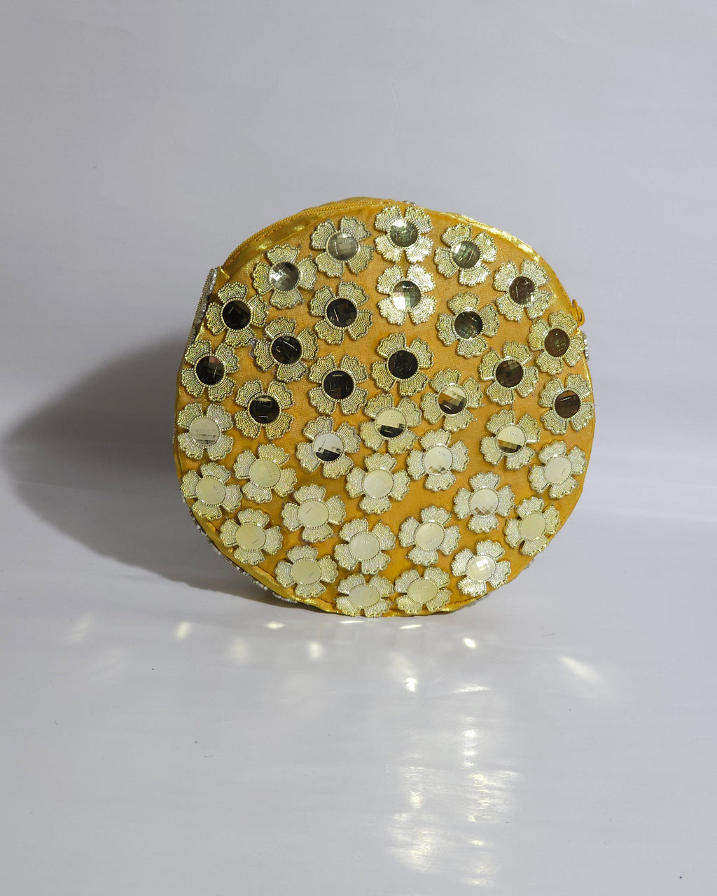 Round CLUTCH BAG with floral patterns on a white background