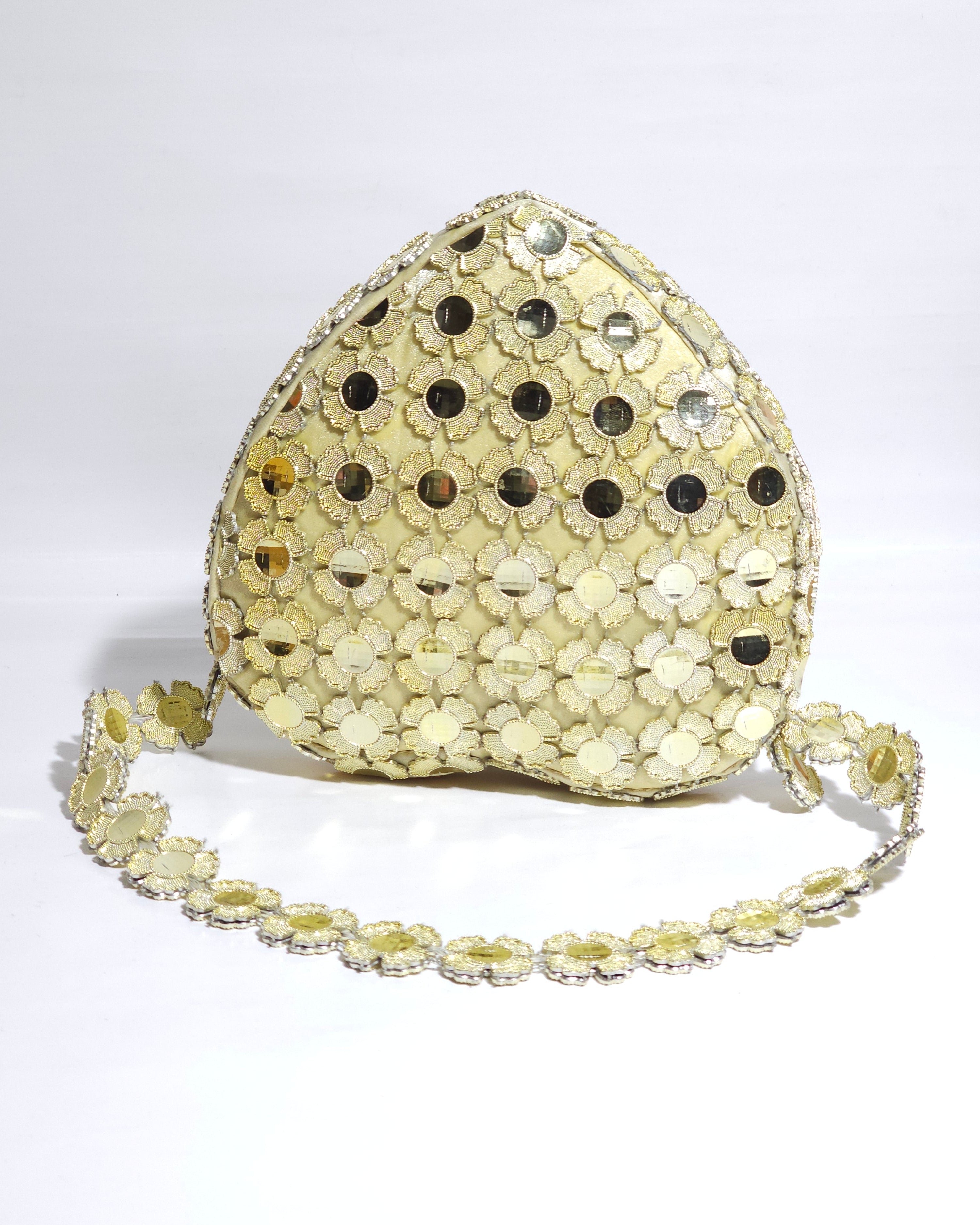 Gold sequin clutch bag on a white background