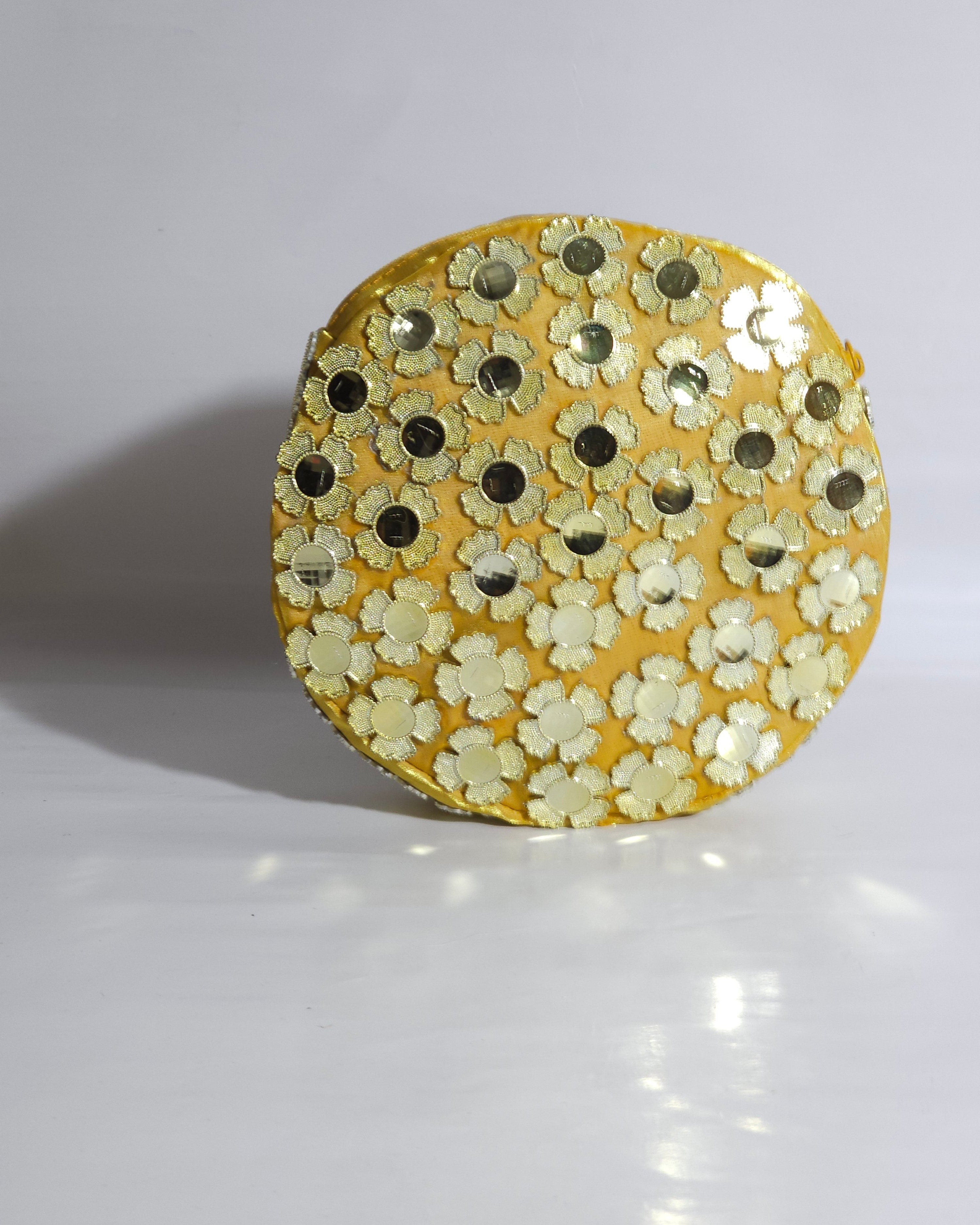 Gold CLUTCH BAG with floral patterns on a white background